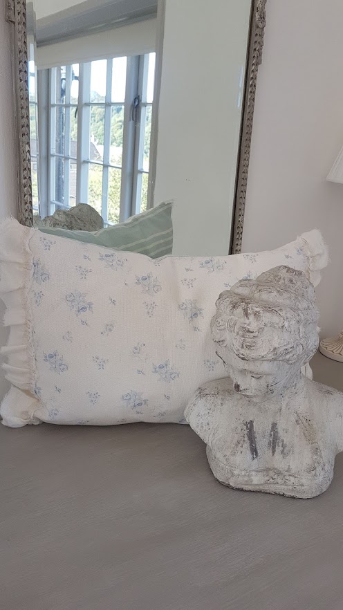 faded french blue roses and powder blue striped ripped edge bolster cushion
